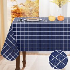 the table cloth is blue and white with black squares on it, along with an orange pumpkin