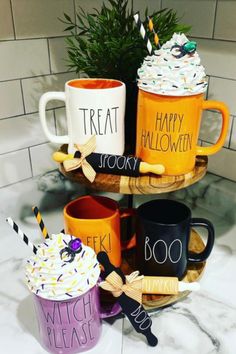 three coffee mugs are stacked on top of each other with the words happy halloween written on them