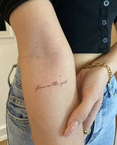 a woman with a small tattoo on her arm