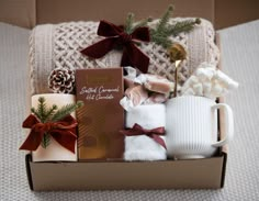 a gift box filled with coffee, marshmallows and other holiday treats