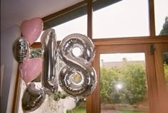 the balloons are shaped like the letter s and have been placed in front of a window