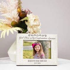 a vase with flowers and a photo frame