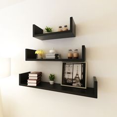 two black shelves with pictures and books on them