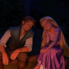 the princess and the frog are sitting next to each other in front of a campfire