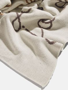 a white blanket with brown designs on it