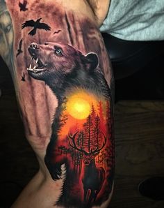 a man's arm with an image of a bear and deer in the woods