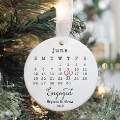 a personalized ornament hanging on a christmas tree in the shape of a calendar