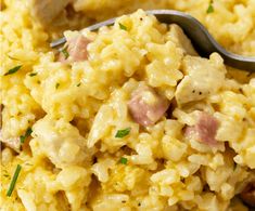 a spoon full of macaroni and cheese with ham