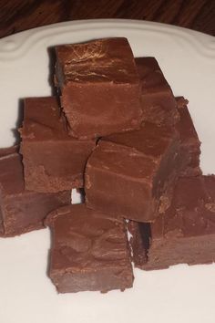 a white plate topped with brownies on top of a wooden table