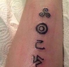 a person with a tattoo on their arm that has numbers and symbols painted on it