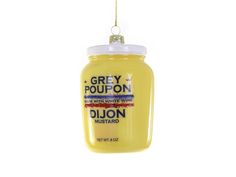 a jar of grey poupon hanging from a string