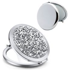 a silver ring with glitter on it and a round mirror in the middle that is open