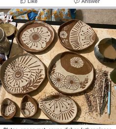 some pottery is sitting on a table with scissors and other crafting supplies next to it