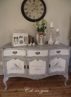 an old dresser with birds painted on it and a clock above the top that says,