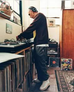 a man standing in front of a record player