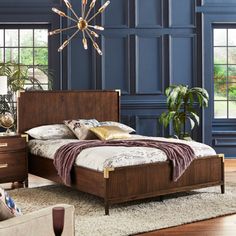 a bedroom with blue walls and wooden furniture