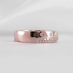 a rose gold ring with diamonds on it