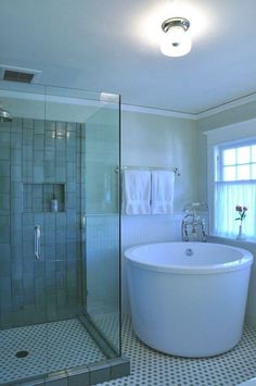 a white bath tub sitting next to a window