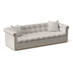 an image of a couch with pillows on it's back and the seat upholstered