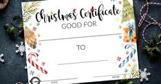 a christmas gift certificate with candy canes and candies on the table next to it