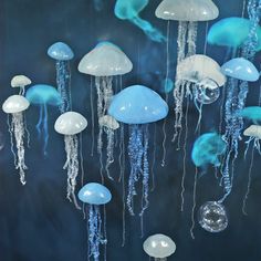 there are many jellyfish hanging from the ceiling