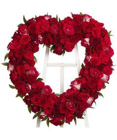 a heart shaped wreath with red roses