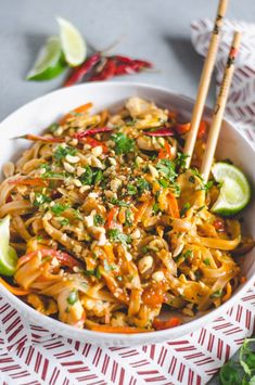 a white bowl filled with noodles and vegetables