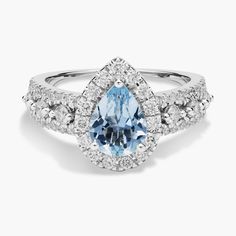 a blue and white ring with diamonds around it