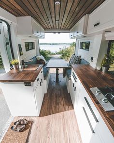 an instagramted photo of a kitchen and living room in a camper trailer