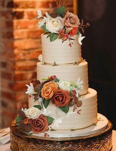 a three tiered cake with flowers on it