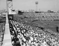 an old black and white photo of a baseball stadium full of people watching the game