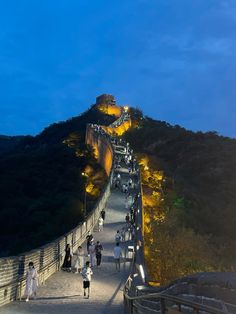 people walking up the great wall at night