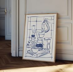 a blue and white drawing sitting on top of a wooden floor