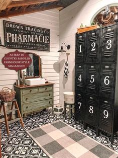 an old fashioned pharmacy cabinet is in the corner of this room with black and white floor tiles