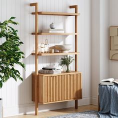 a wooden shelf with books and plants on it