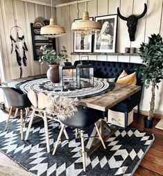 a dining room table with black chairs and pictures on the wall above it, along with other decor items