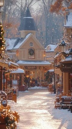 a snowy street lined with shops and christmas decorations