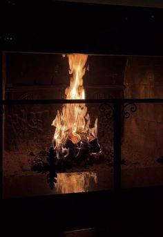 a fire burning in a fireplace with lots of flames