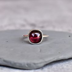 ✦  This Red Garnet handmade ring will make you feel like a million bucks.  The Ethically sourced Red Garnet cushion cut stone is set in a sterling silver band for a simple and clean look.  Whether you're looking for something special to show your significant other how much you care, or simply want to treat yourself to a little luxury, this ring is sure to please.  💎  Please Note As with all Natural Gemstones The colors and inclusion patterns if applicable may vary slightly. -- -- »» DETAILS - Cushion Cut Ruby Rings For Gift, Ruby Cushion Cut Rings For Gift, Unique Silver Garnet Rings, Silver Garnet Ring With Prong Setting, Handmade Red Garnet Ring, Red Garnet Crystal Ring With Gemstone, Red Garnet Rings With Polished Finish, Red Garnet Ring, Ring Cushion