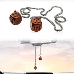 two dices hanging from the back of a car