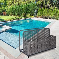 a pool with a fence around it and some trees in the back yard behind it