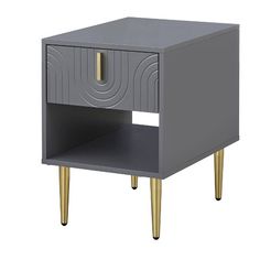 a grey and gold side table with an open drawer on the bottom, in front of a white background