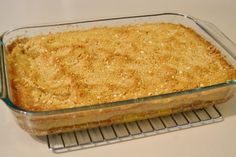 a casserole dish is sitting on a cooling rack