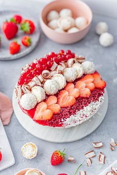 a cake decorated with strawberries and marshmallows