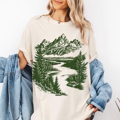 This design is printed on a super cozy unisex Comfort Colors tee. Comfort Colors uses the direct to garment style of dye, meaning the shirt is made first, and then it is dyed. This gives the shirt a vintage, weathered appearance, with lived-in rich colors inspired by nature. It's 100% cotton, and preshrunk, so you don't have to worry about it suddenly fitting a very small child. The cotton gets softer and softer after each wash. This is a unisex tee - if you like a trendy oversized look, go up 1-2 sizes.  * S I Z I N G * ✦ Shirts are true-to-size for UNISEX fit ✦ Please see size guide in the listing photo for all measurements and information. ✦ We DO NOT accept returns, exchanges, or refunds for incorrect fit, so please choose your size wisely! * C A R E * ✦ Items should be washed on DELIC River Scenery, Forest Mountain, Mountain River, Outdoor Shirt, Comfort Colors Tee, Rich Colors, Outdoor Hiking, Linocut, Nature Inspired