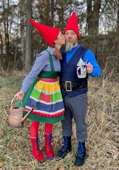 a man and woman dressed up as gnomes kissing