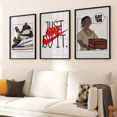 three framed pictures hang on the wall above a white couch in front of a window