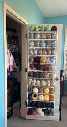 a closet filled with lots of yarn and crochet items next to a window