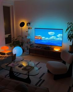 a living room filled with furniture and a flat screen tv on top of a wall