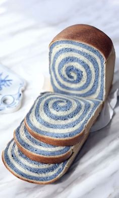 a loaf of bread with blue and white swirls on it sitting on a table